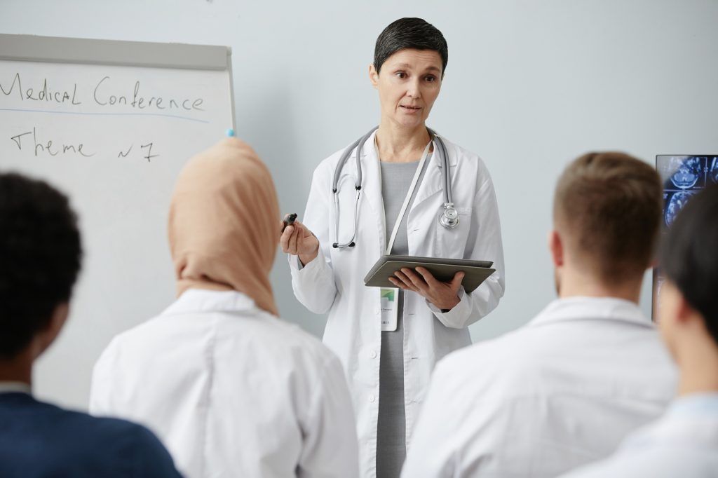 Doctor giving lecture to audience at medical seminar