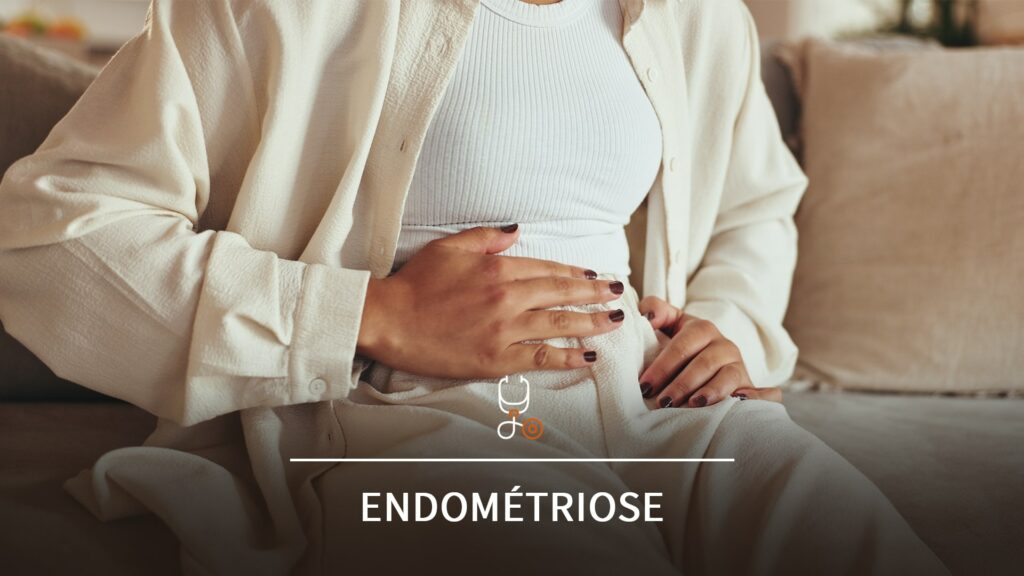 Femme assise tenant son bas-ventre avec les deux mains, exprimant un inconfort abdominal, avec le mot "Endométriose" en surimpression.